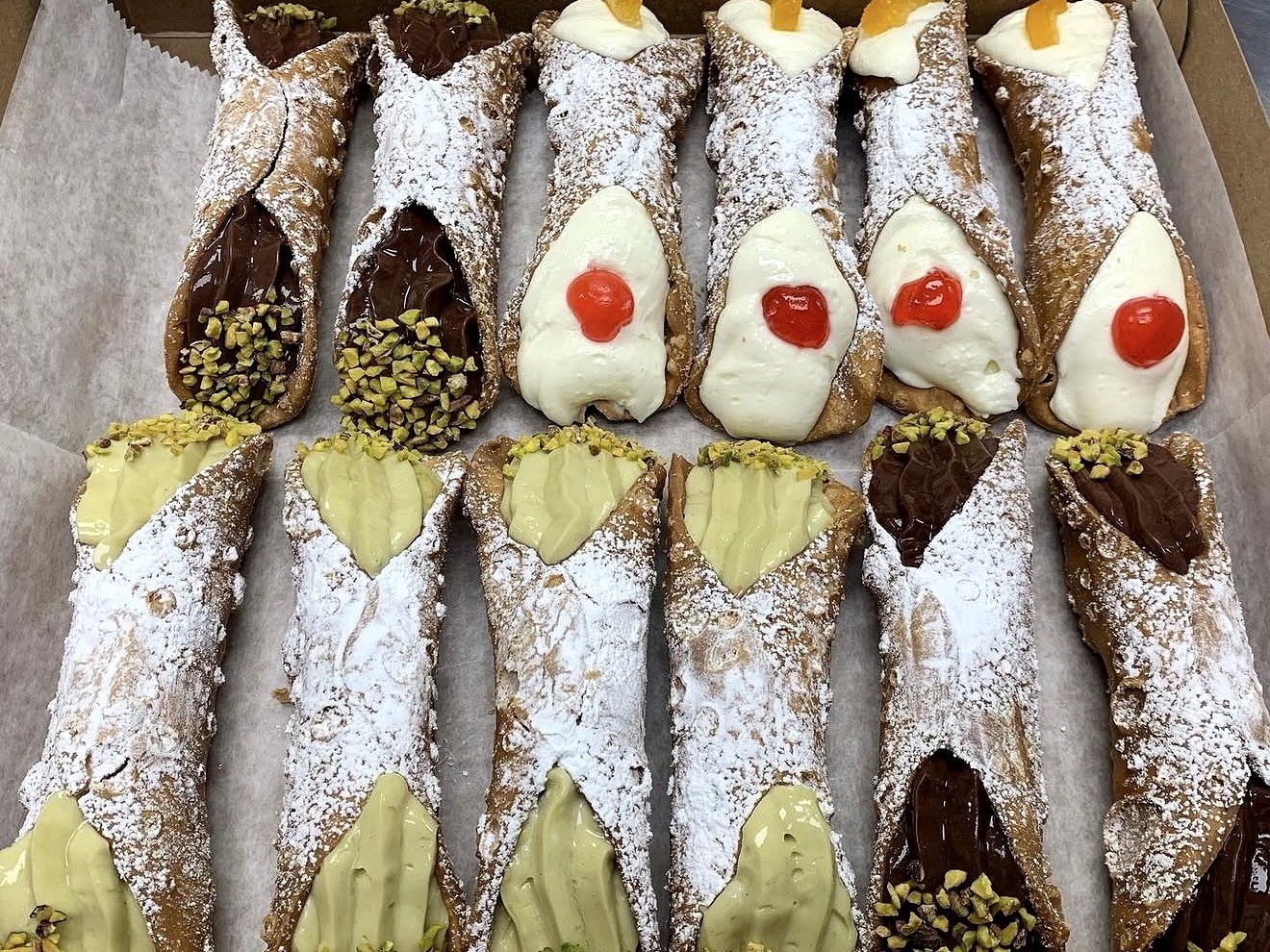 Box of assorted Italian cannoli with chocolate, pistachio, and ricotta fillings from Four Seasons