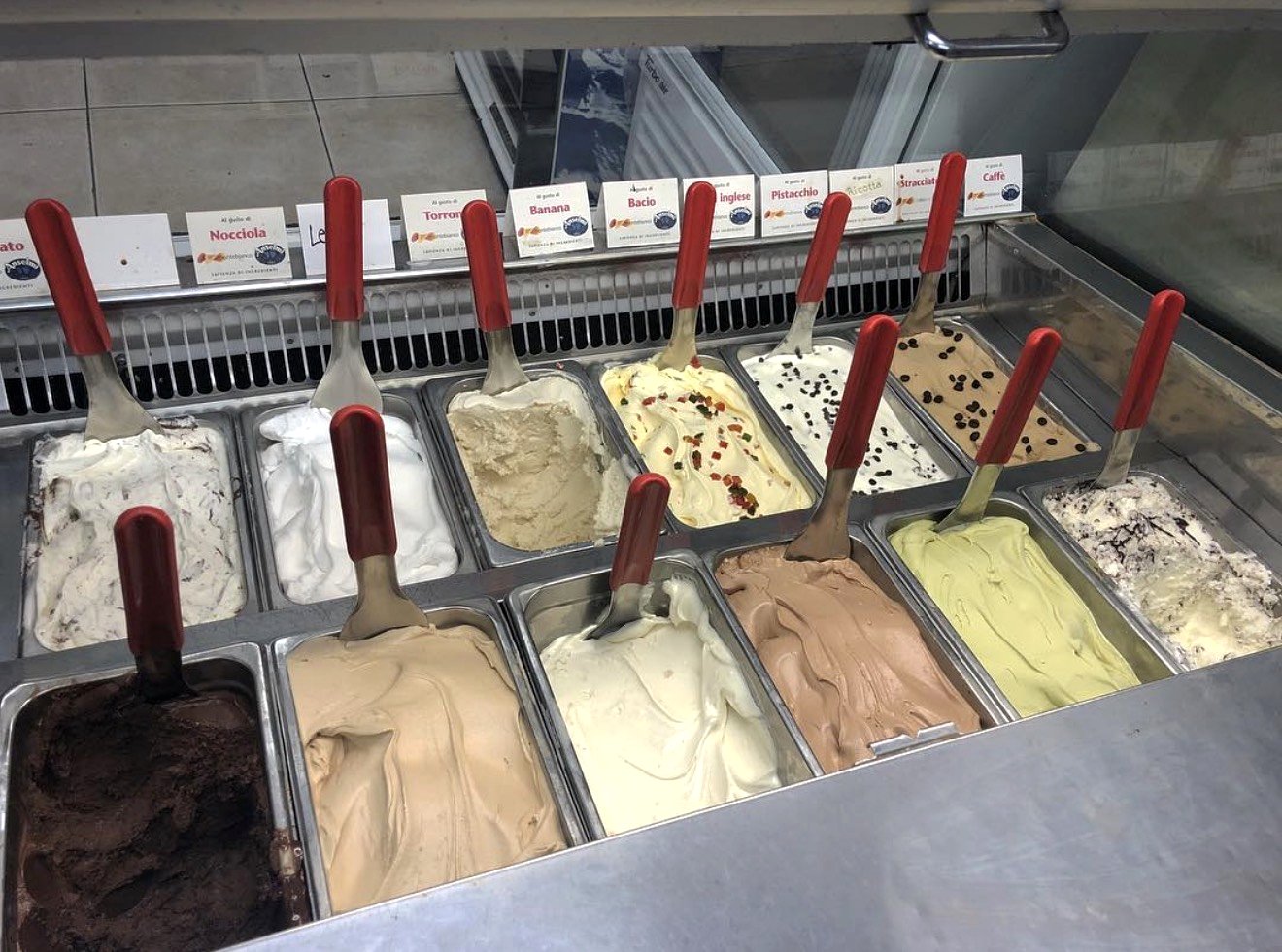 Gelato display case with Italian flavors including Pistacchio, Nocciola, Bacio, Stracciatella, and Caffe at Four Seasons Elmwood Park NJ
